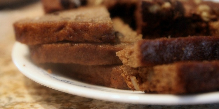 Zoomed in image of honey cake on a white plate.