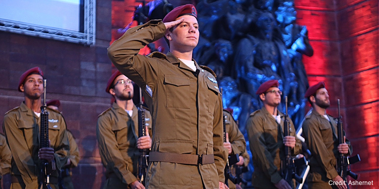 IDF soldiers standing at attention in honor of the singing of the Hatikvah national anthem, salute