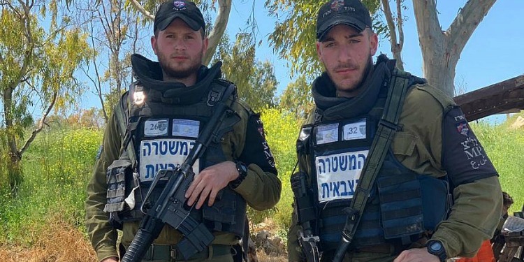 Two armed soldiers looking directly at the camera.