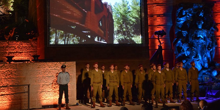 Several IDF soldiers standing on a stage for a presentation.