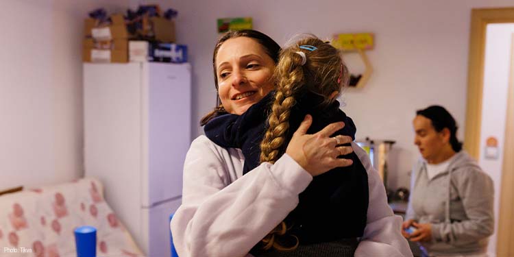 IFCJ Staff hugging young girl