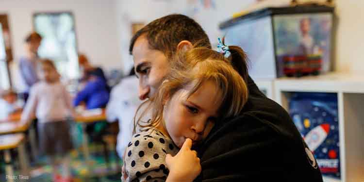 IFCJ employee hugs young girl