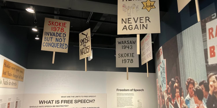 While the Skokie location is closed for renovations, the Illinois Holocaust Museum has opened an exhibit space in downtown Chicago, continuing its mission of sharing the stories and history of the Holocaust and transforming them into lessons about civil rights and genocide. International Holocaust Remembrance Day is a time to open our eyes and ears to the horrors experienced and inflicted during that period, and the museum’s special presentation of Experience360 does just that in a new and innovative way. The Illinois Holocaust Museum was founded in 1981 in response to a proposed neo-Nazi march in Skokie in 1976. The entry corridor to the museum space is themed around this event. Holocaust survivors who had resettled in Skokie—at the time home to the largest per capita population of survivors outside of Israel—were not willing to run and hide. Accompanied by their neighbors, they organized a march of their own. The signs they carried now hang from the ceiling and line the walls, alongside newspaper clippings from the time. Legal battles followed over whether the neo-Nazi group’s hateful rhetoric was protected under the First Amendment, sparking ongoing debate. For those who survived what that rhetoric represented, and for those who understand history, this was never a matter for debate. The museum was founded to educate—and to explain why.