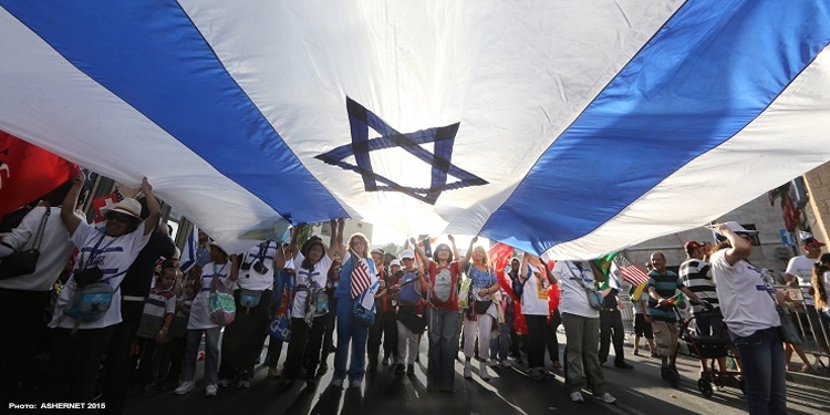 A group of people holding the Israeli flag over their heads