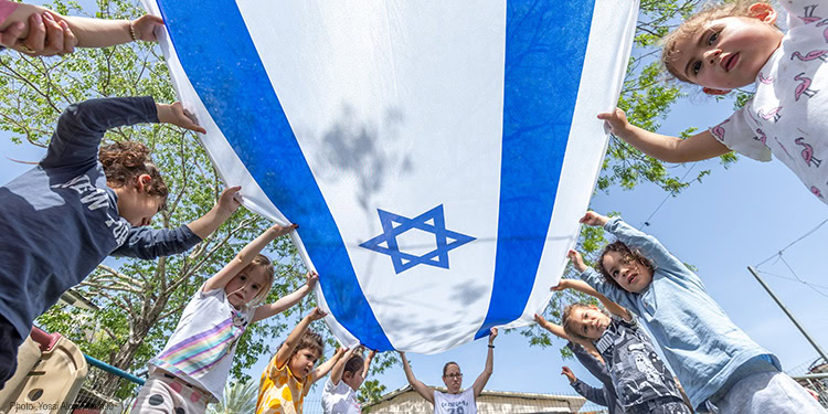 Israeli children playing Israeli flags