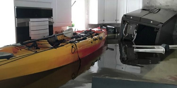 A kitchen completely underwater from a flood.