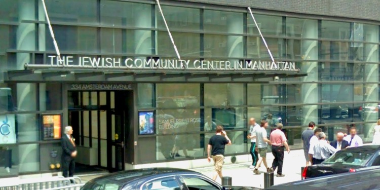 People on the street walking by The Jewish Community Center in Manhattan.