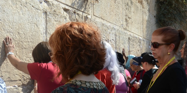 Large group of women praying at the Western Wall.