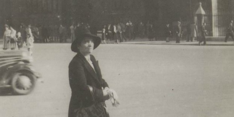 Dated image of Jeanne Albouy walking in the street.