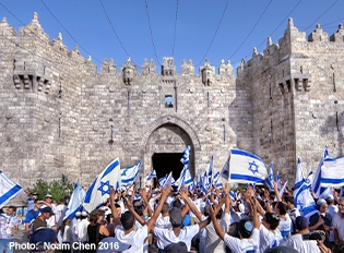 Israeli Jews celebrating Jerusalem Day in the Old City of Jerusalem with Israeli flags. 