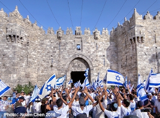Israeli Jews celebrating Jerusalem Day in the Old City of Jerusalem with Israeli flags.