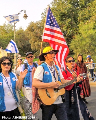 U.S. Christians joining in the annual Sukkot march in Jerusalem, carrying the American and Israeli flags.