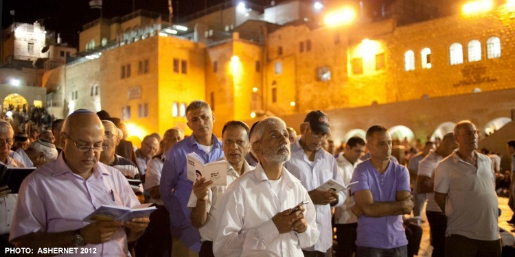 Jewish men praying at the Western Wall during Yom Kippur
