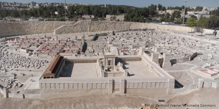 Archaeological site of a Second Temple era burial cave with stone tombs and artifacts, uncovered by police, showcasing historical Jewish burial practices.