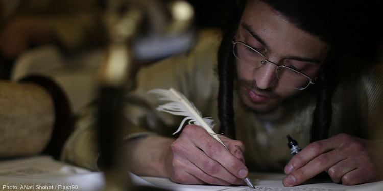Ultra orthodox Jews seen writing in a newly inscribed Torah scroll (a handwritten copy of the Torah, the holiest book within Judaism) before it will be brought into a synagogue in the ultra orthodox Jewish neighborhood of Meah Shearim.