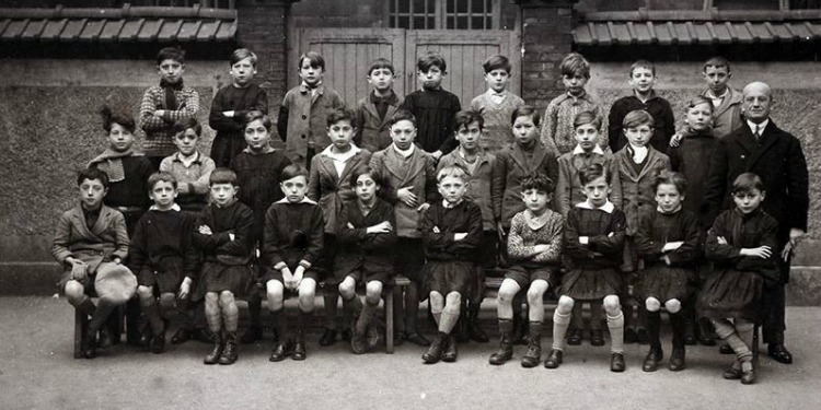 Black and white image of several children and their principal.