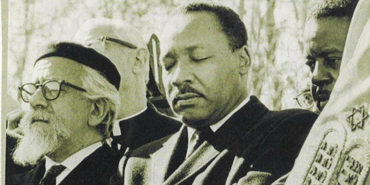 Dr. Martin Luther King Jr. and Rabbi Heschel praying together.
