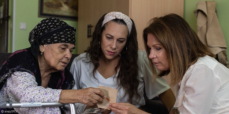 Michele Bachmann and Yael helping an elderly woman