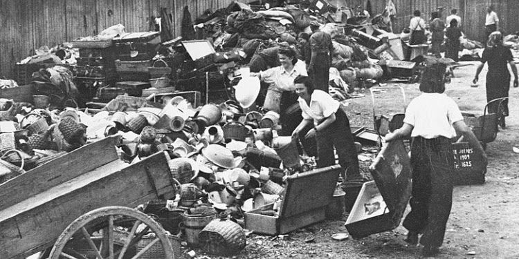 Black and white photo of women gathering vases and pots and piling them together.