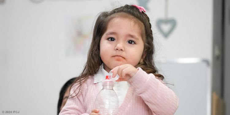 Little girl wearing a pink sweater