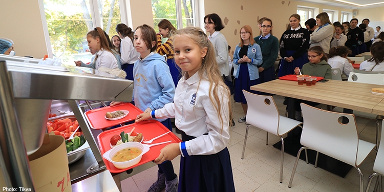 Little girl standing in the cafeteria line