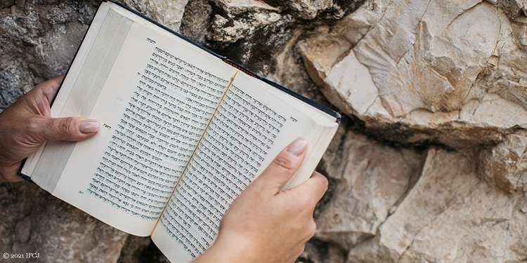 Holding a bible at the Western Wall