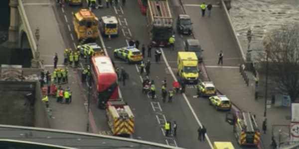 Aerial view of several cars and medics gathered on the street.