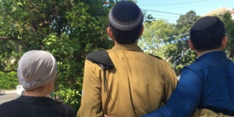 The backs of an IDF soldier with his parents.