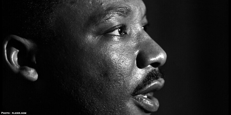 Black and white image of MLK looking off into the distance.