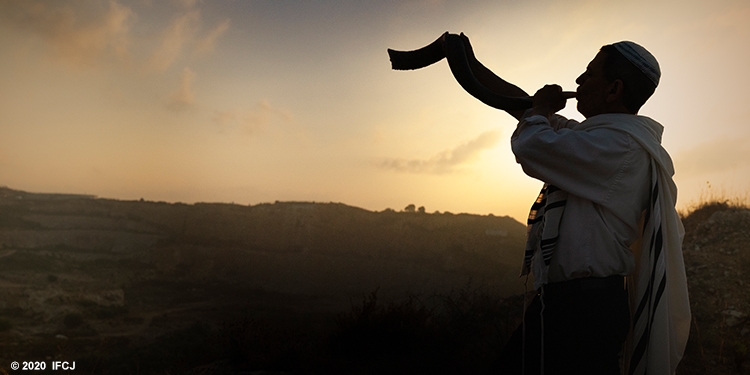 Man blowing a shofar for Rosh Hashanah