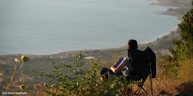 Man sitting in chair enjoying the sunset.