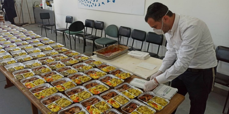 Packing meals for delivery at Mana Hama Soup Kitchen during coronavirus crisis