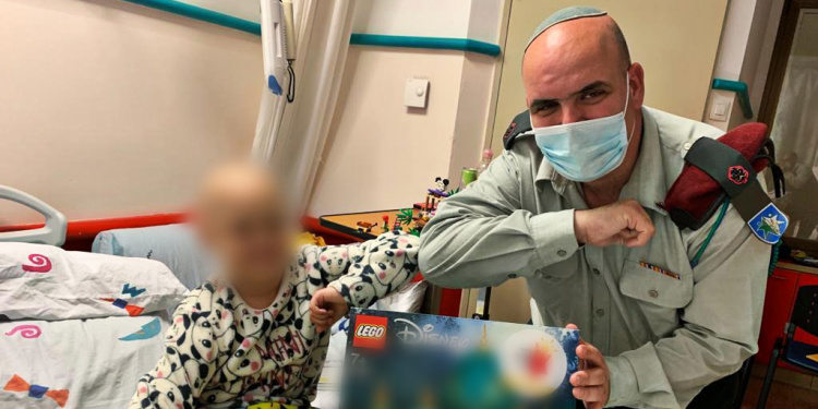 Maor Cohen, retired IDF officer giving Lego set to sick child in Israel