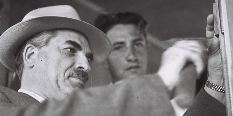 Israeli Interior Minister Moshe Shapira hangs a mezuzah in Kibbutz Masu'ot Yitzhak, 1949.