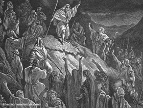 Black and white cartoon of men in robes gathering at a rock.