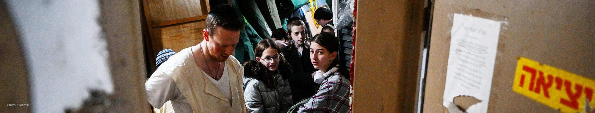 Individuals in a bomb shelter during a missile attack in Israel.