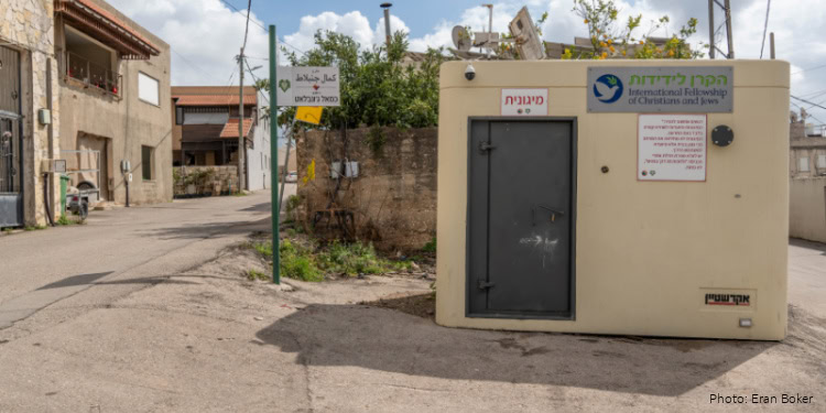 This image depicts a community aid station in Israel, serving as a vital resource for local residents by providing humanitarian support, essential supplies, and community assistance in a neighborhood setting.