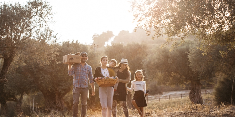 Yael Eckstein and family stand in olive tree grove in Israel