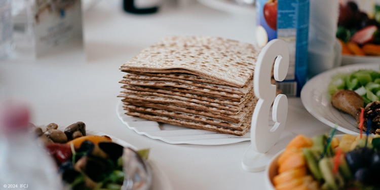 Stack of matzah on plate, white tablecloth, food