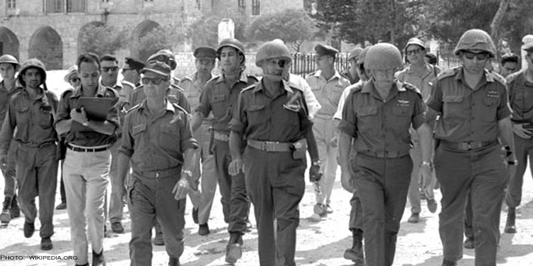 Black and white image of soldiers walking towards the camera.