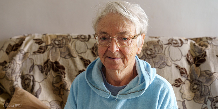 Elderly woman sitting on couch