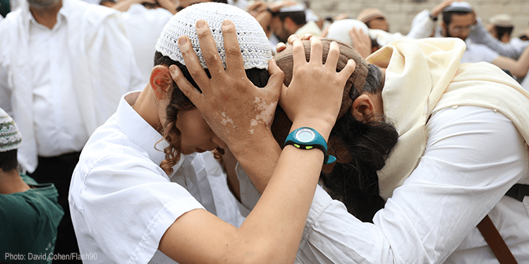 Orthodox Jews sing and dance during a prayer
