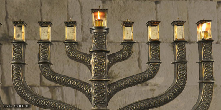 A large metal Menorah with two candles lit