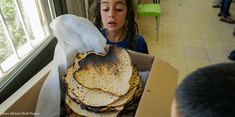 Orthodox Jews bakingShmurah Matzah after mid-day