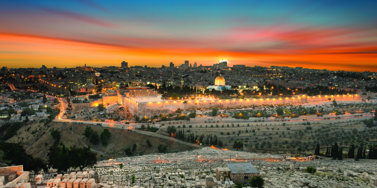 The city of Jerusalem during an orange sunset.
