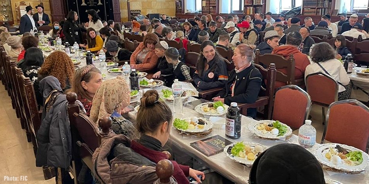 Banquet hall full of people eating.