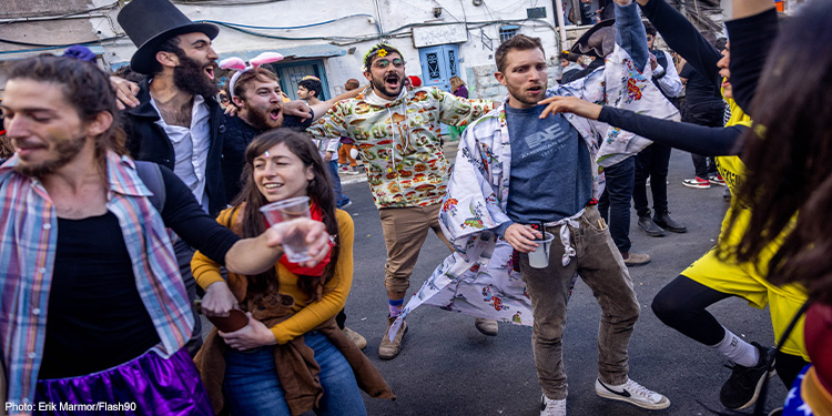 People dressed up in costumes party at the Nachlaot neighborhood of Jerusalem