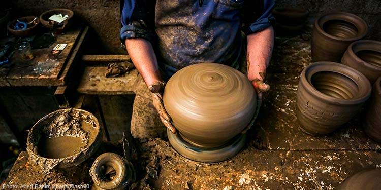 Palestinian potter Sid Atallahand his two sons, prepares pots at the family workshop in Deir al-Balah in the central Gaza Strip