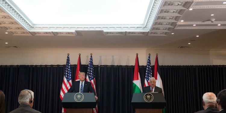 President Trump and President Abbas standing at two podiums as they have a joint press conference.