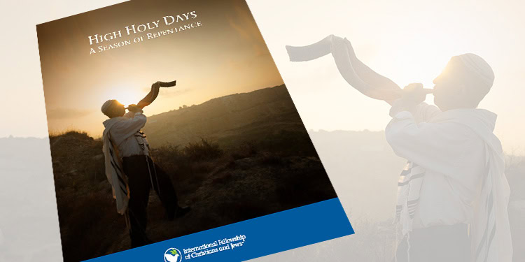 A person blowing a shofar during sunset, symbolizing reflection and repentance for the High Holy Days.
